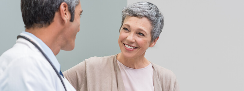 A woman smiling at her doctor.