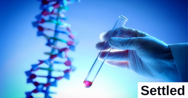 A hand holds a test tube vial beside a strand of DNA.
