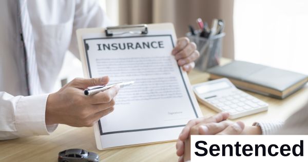 A person displays a tablet with insurance papers on it.